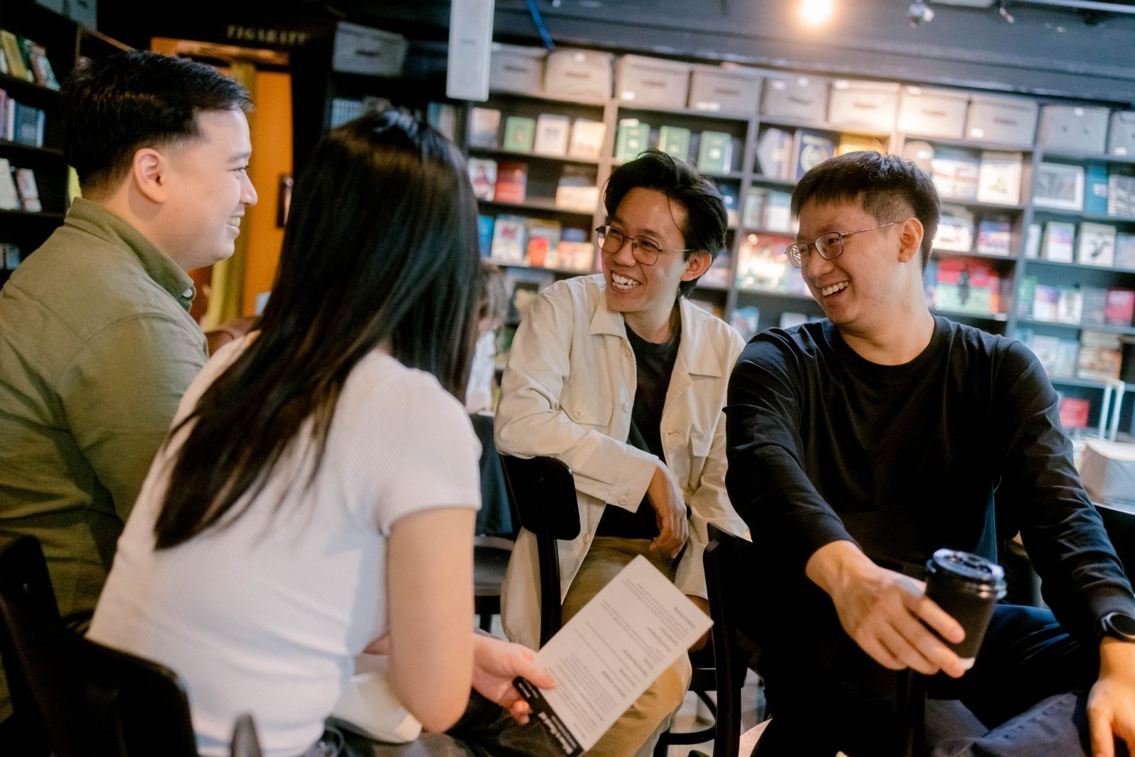 People greeting one another in the sunlit foyer before a Sunday service, with a welcome desk to one side.