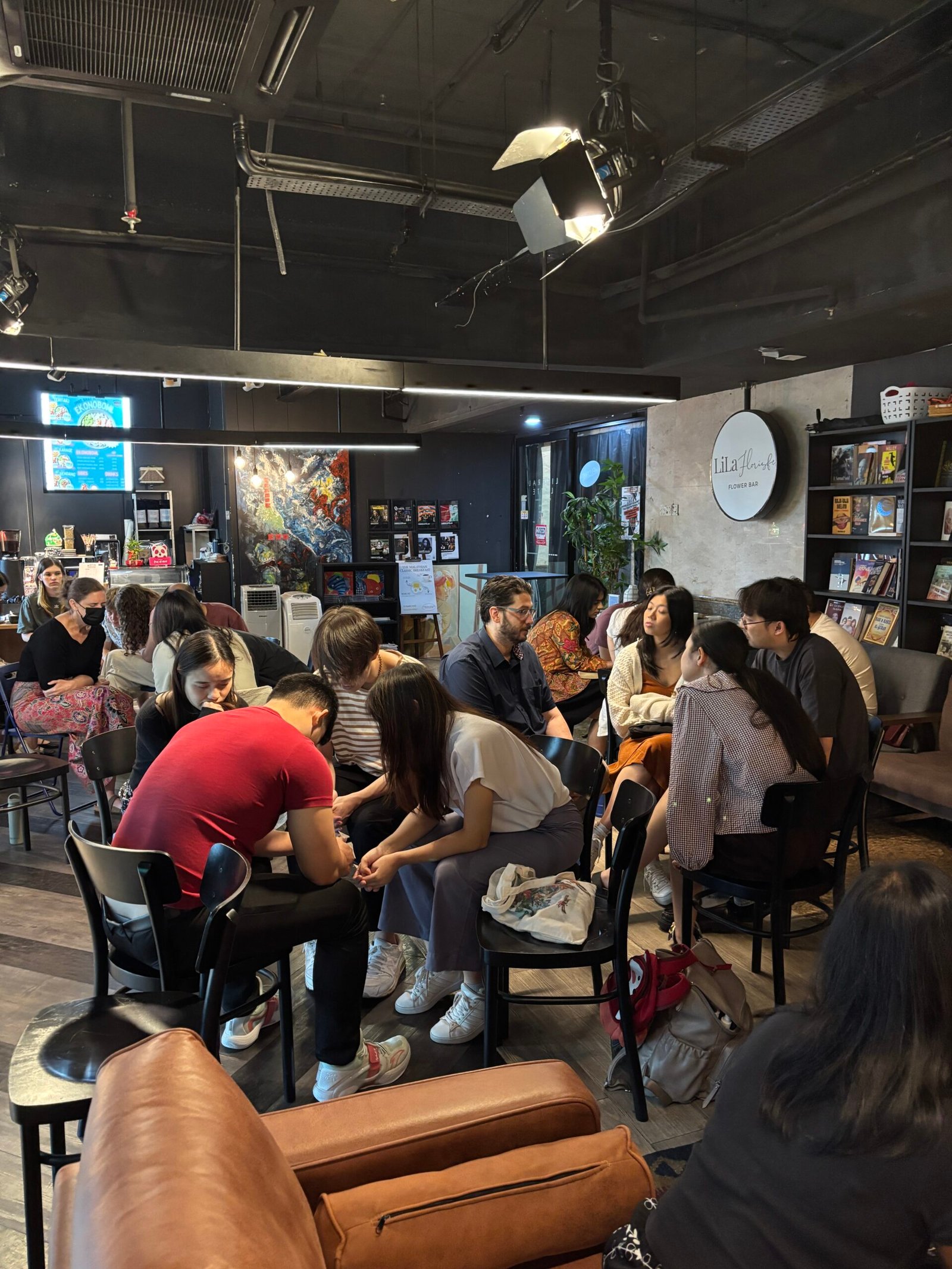 Young adults sitting together praying